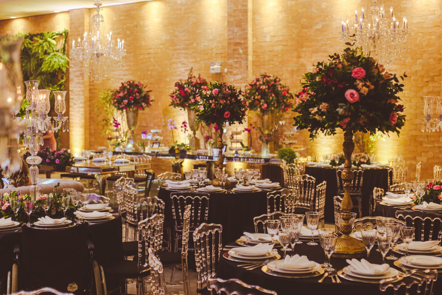 Ballroom wedding venue with chandeliers and floral displays
